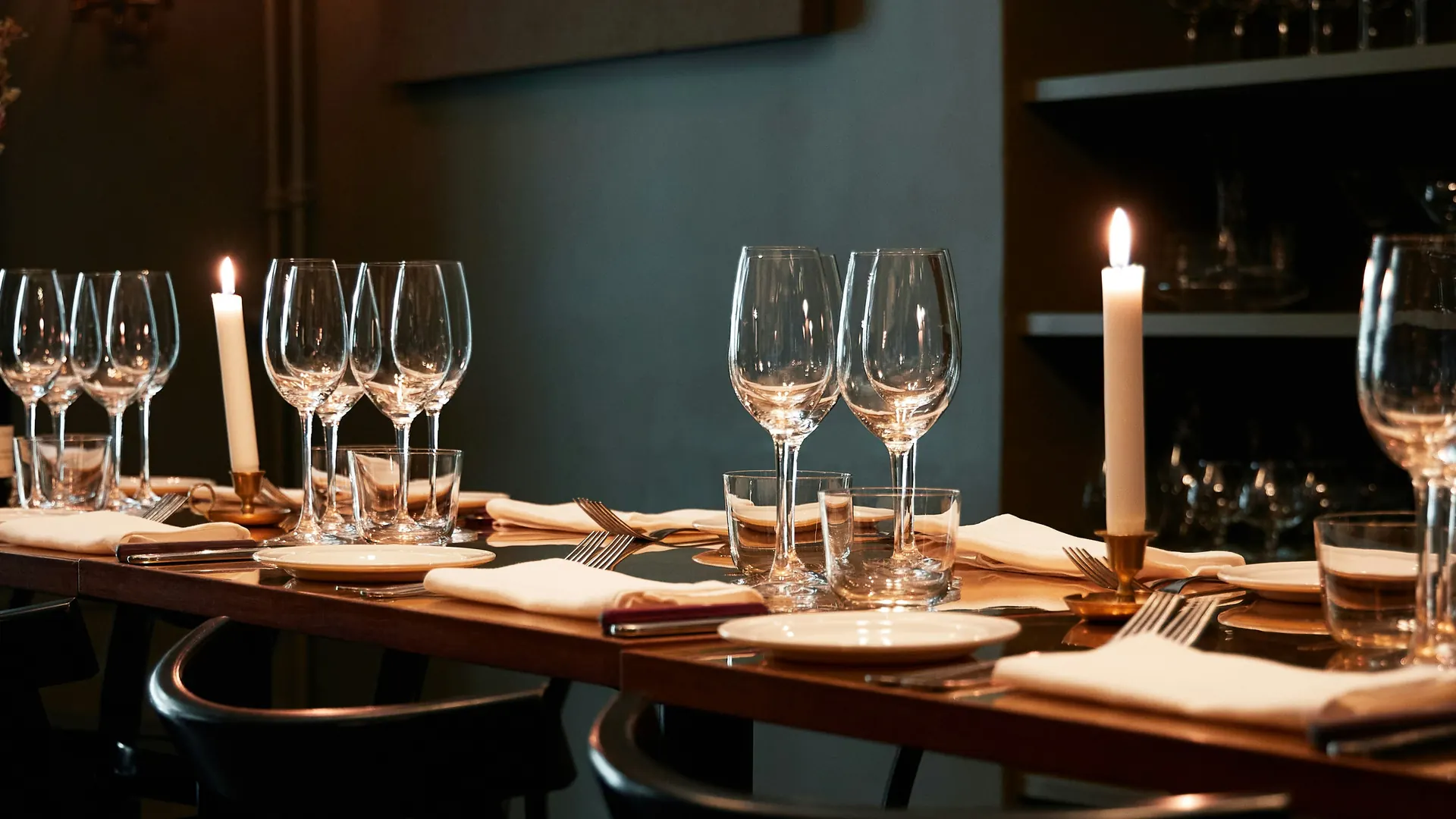 A candlelit private dining table laid for dinner